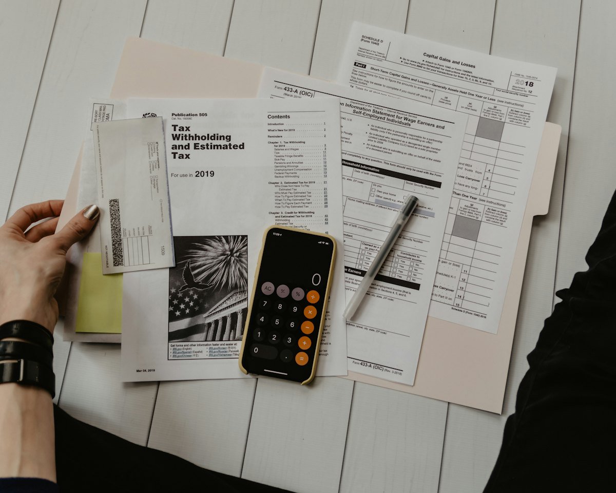 Working through household numbers with a calculator and paperwork