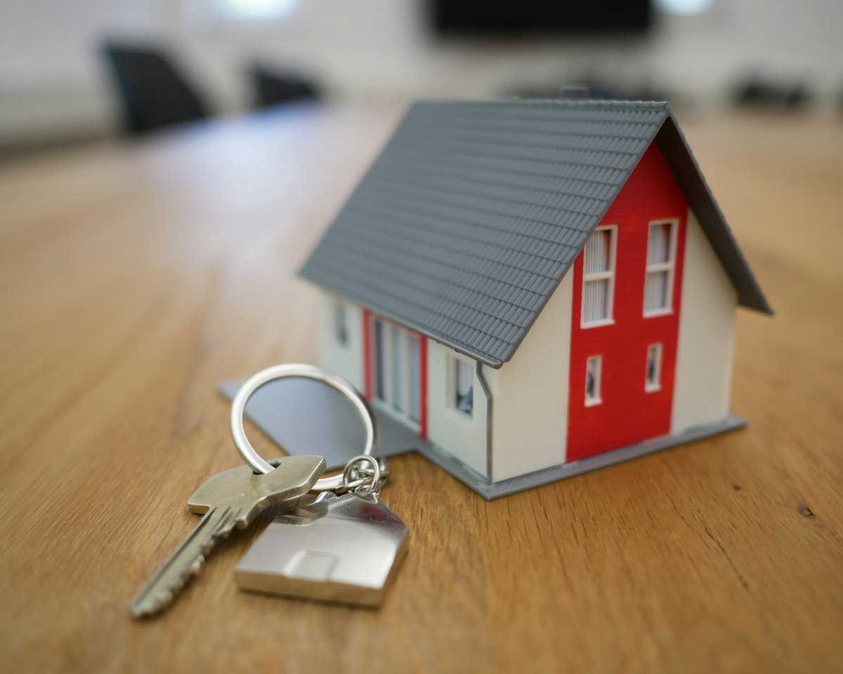 House keys held up in front of a new home